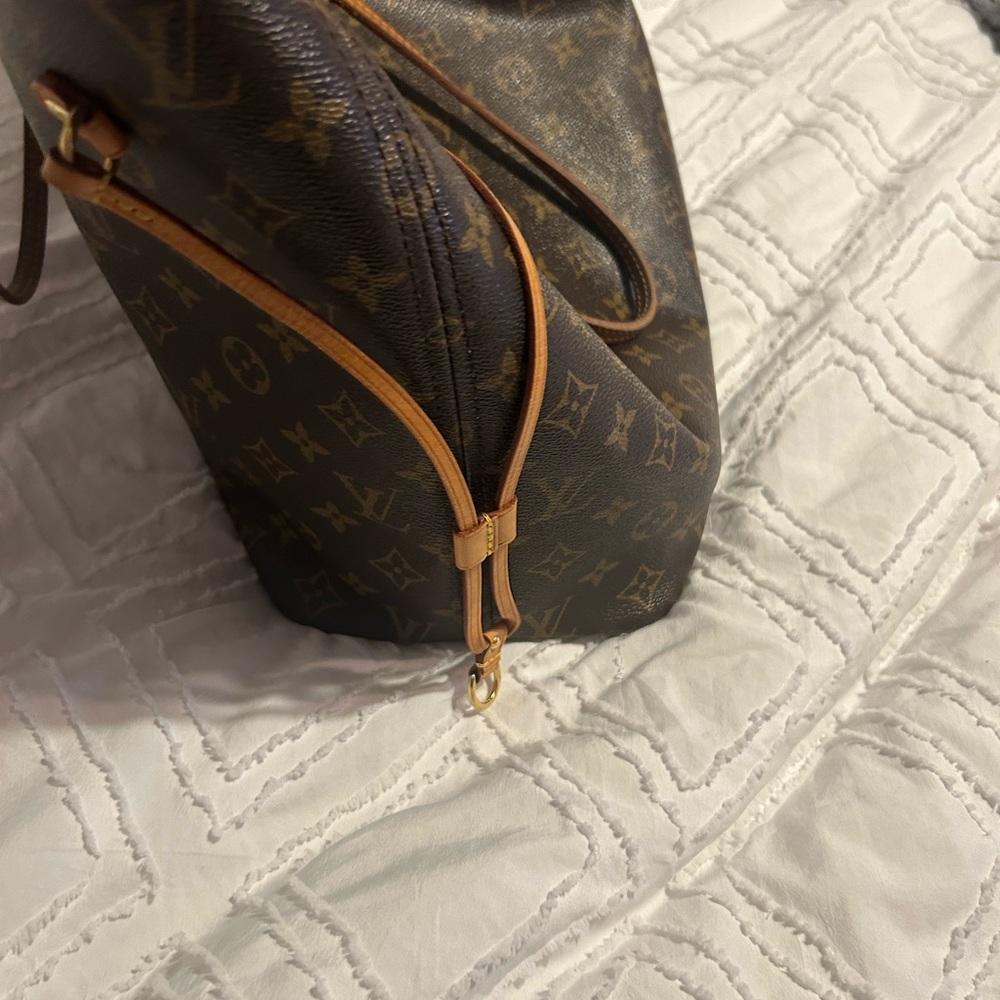 Louis Vuitton handbag with matching wristlet.